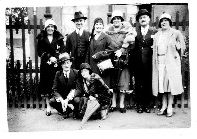 Groupe de personnes des années 1930 qui posent dans la rue